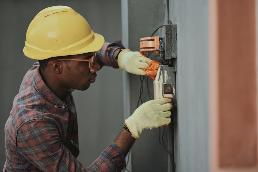 Electrician working on a wall-mounted electrical box