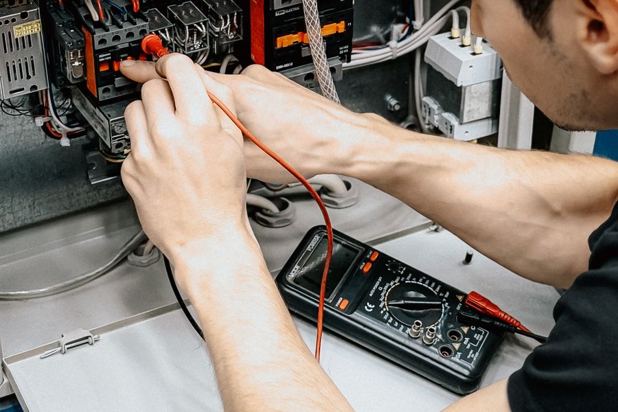 Electrician testing circuits with a multimeter